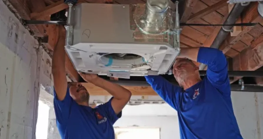 Williams Air Solutions technicians installing a new air conditioning system at a Pinellas County home