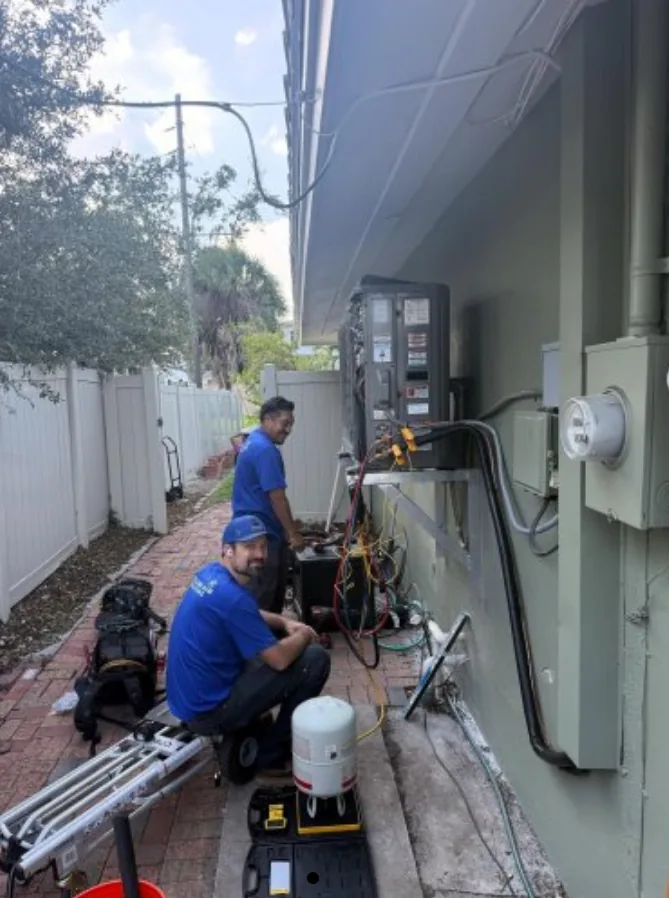 Williams Air Solutions technicians installing a ductless mini split indoor unit in a Pinellas County home