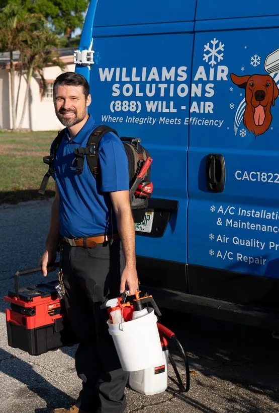 A Williams Air Solutions technician beside the company service van in Belleair, Florida